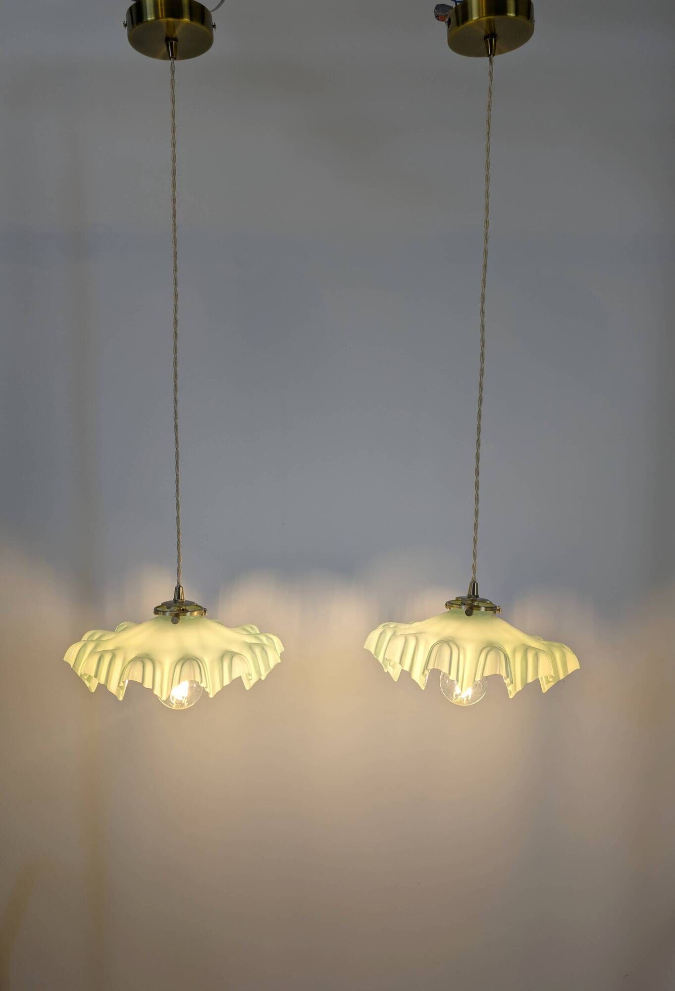 Pair of green opaline glass pendant lights – frosted poetry & Art Deco brilliance