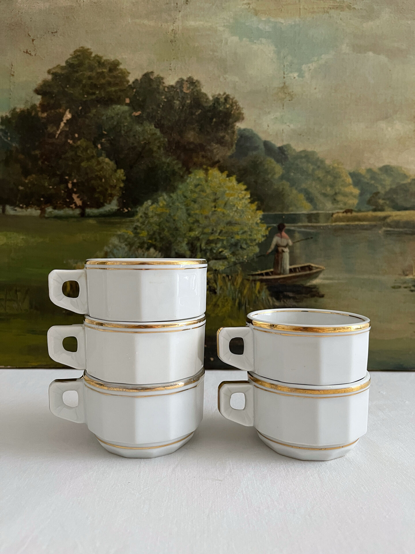 5 vintage porcelain bistro coffee cups from Paris with gold trim.