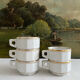 5 vintage porcelain bistro coffee cups from Paris with gold trim.