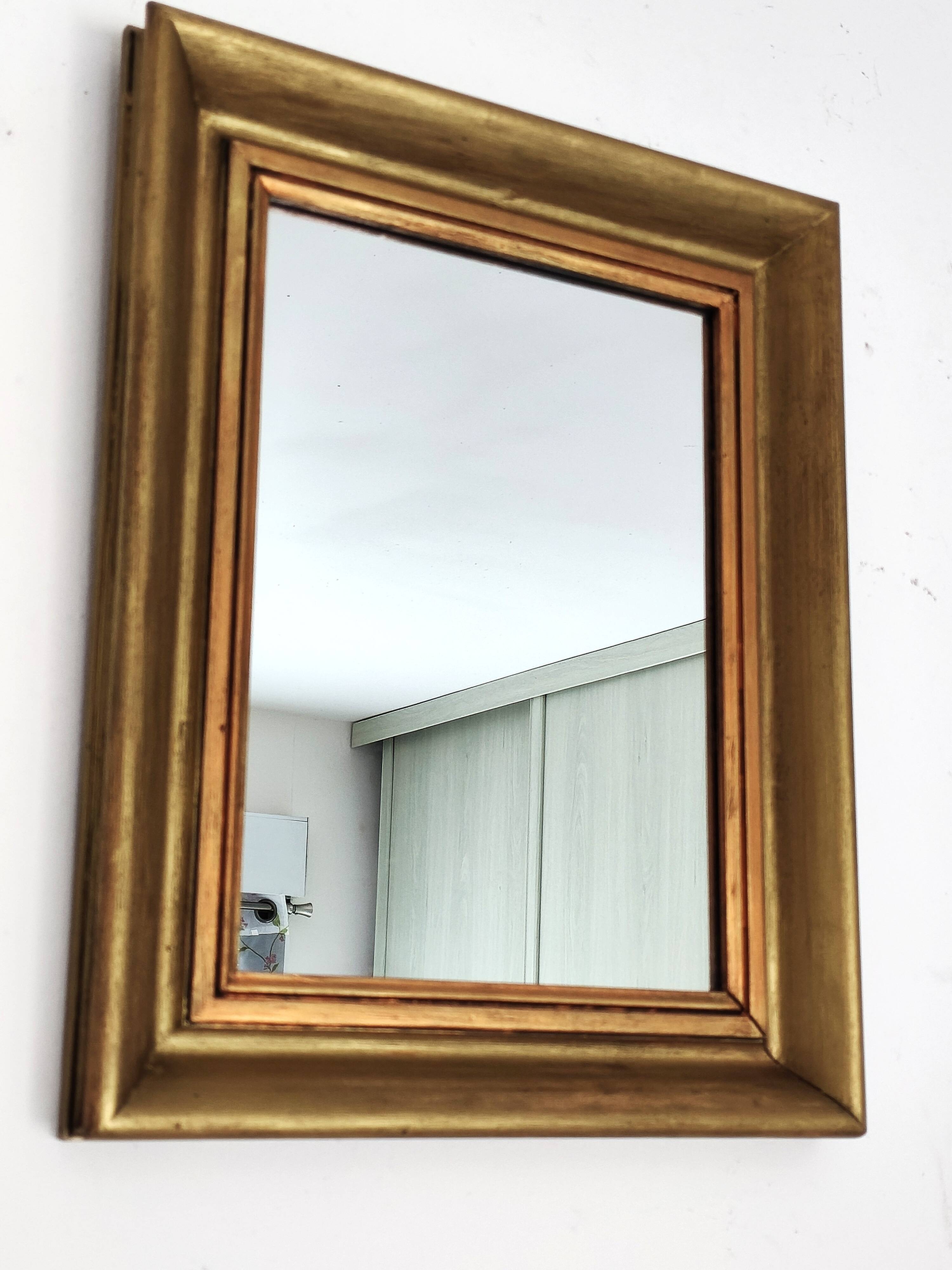 Antique mirror in gilded and copper wood