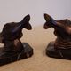 Art Deco pair of bookends with stylised fish in patinated metal and marble.
