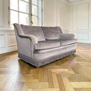 Vintage taupe two-seater armchair/sofa with fringes.