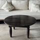 Antique round coffee table in Indonesian teak with turned legs.
