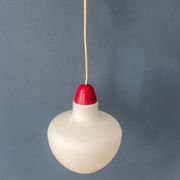 Mid-Century opaline glass suspension with a red upper part and ceiling cover.