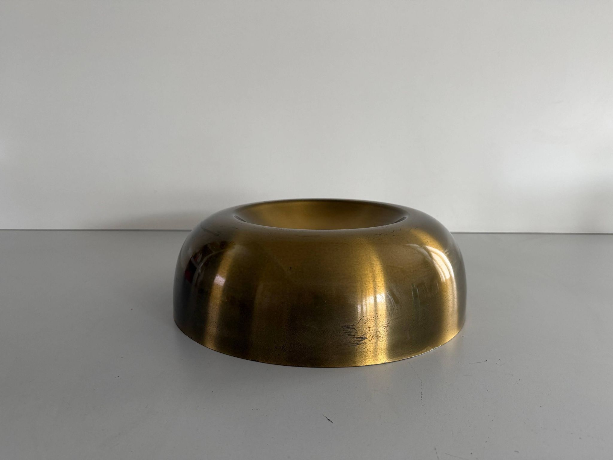 Flush-mounted disc-shaped brass fixture from the mid-century, 1960, Italy.