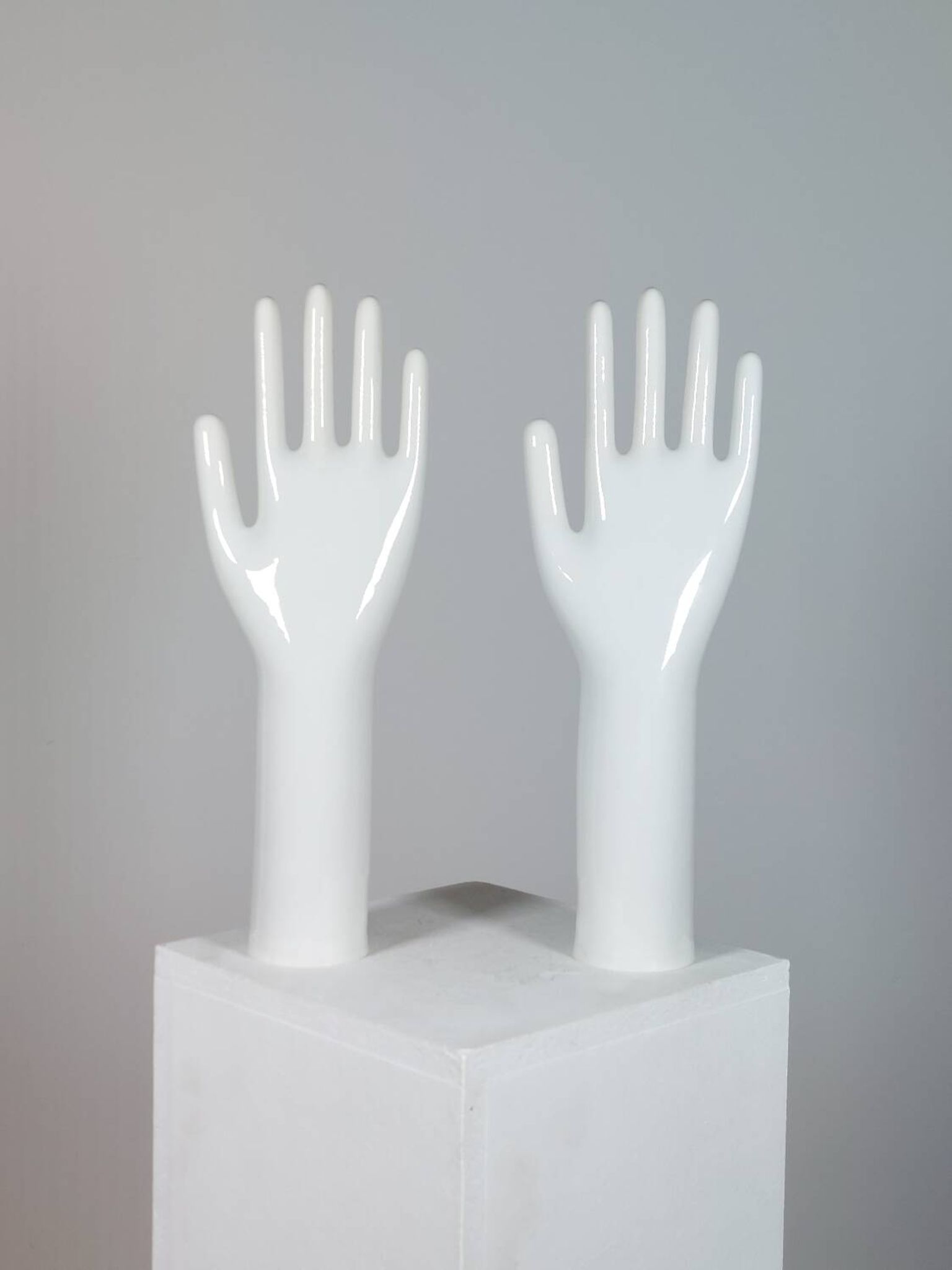 Pair of authentic vintage jewellery displays in industrial porcelain representing hands.