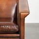 Sleek sheepskin Art Deco design armchair with black piping