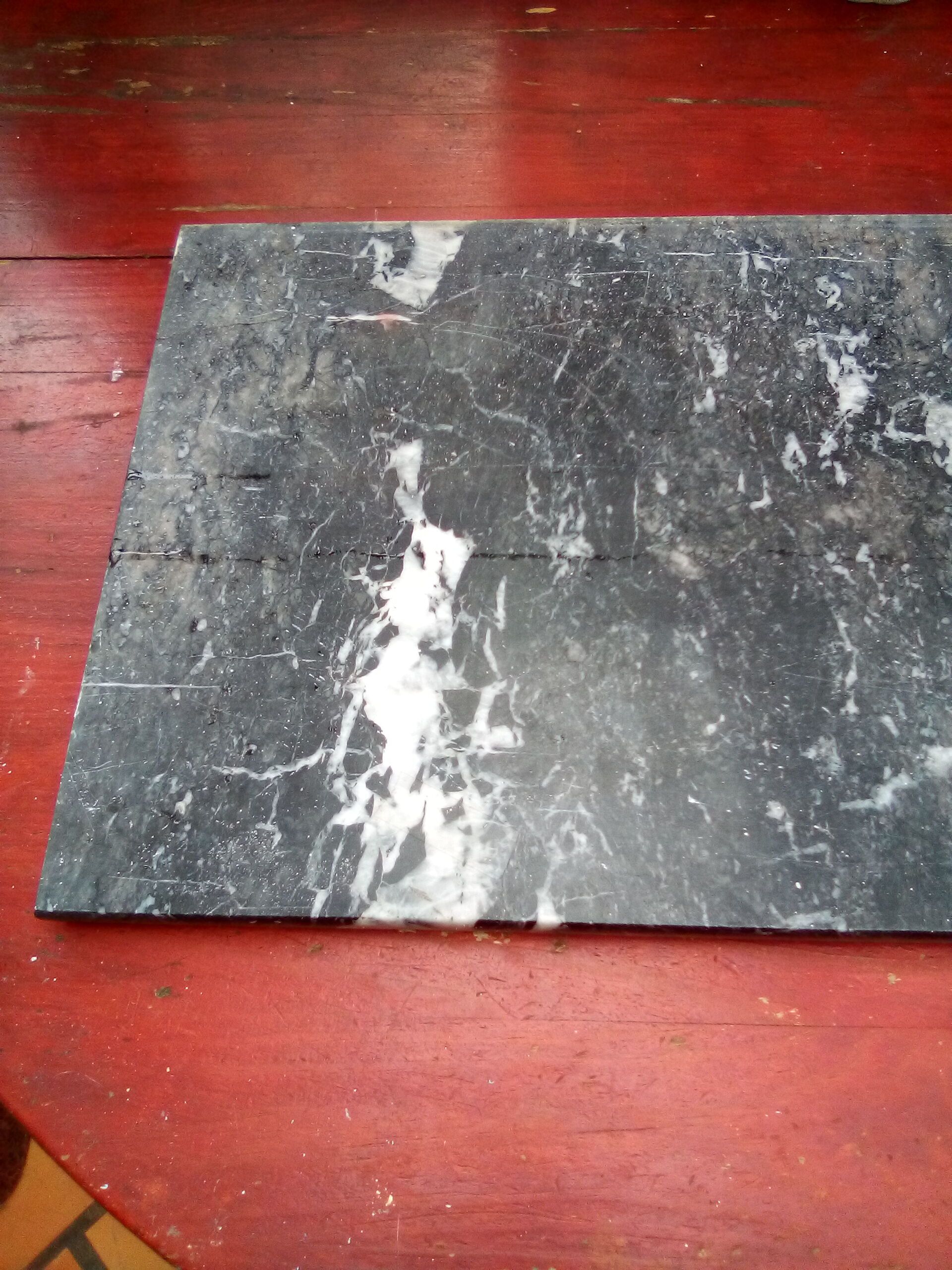 White veined black marble fireplace