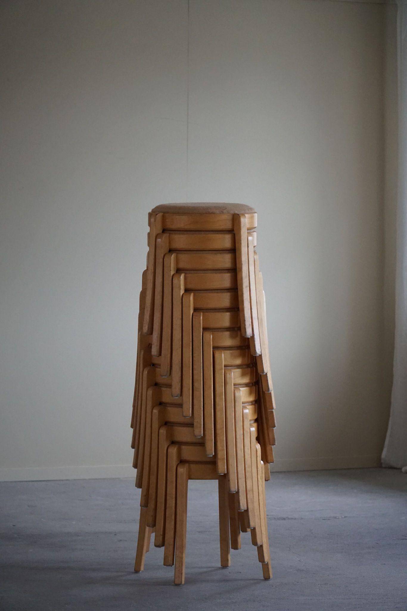Modern Swedish, set of 14 stackable stools in birch and hessian fabric, 1980s.