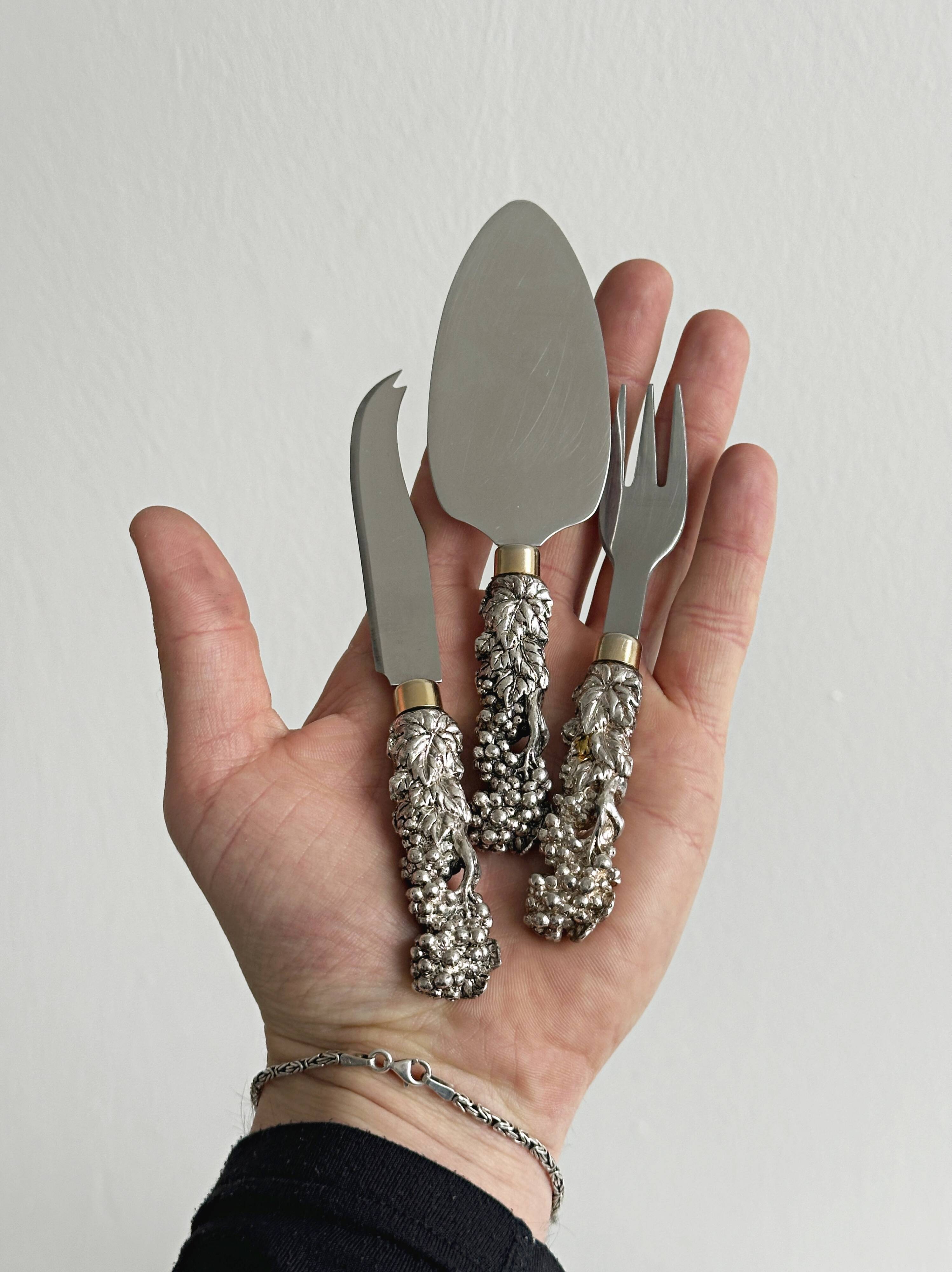 Antique shiny metal cheese cutlery