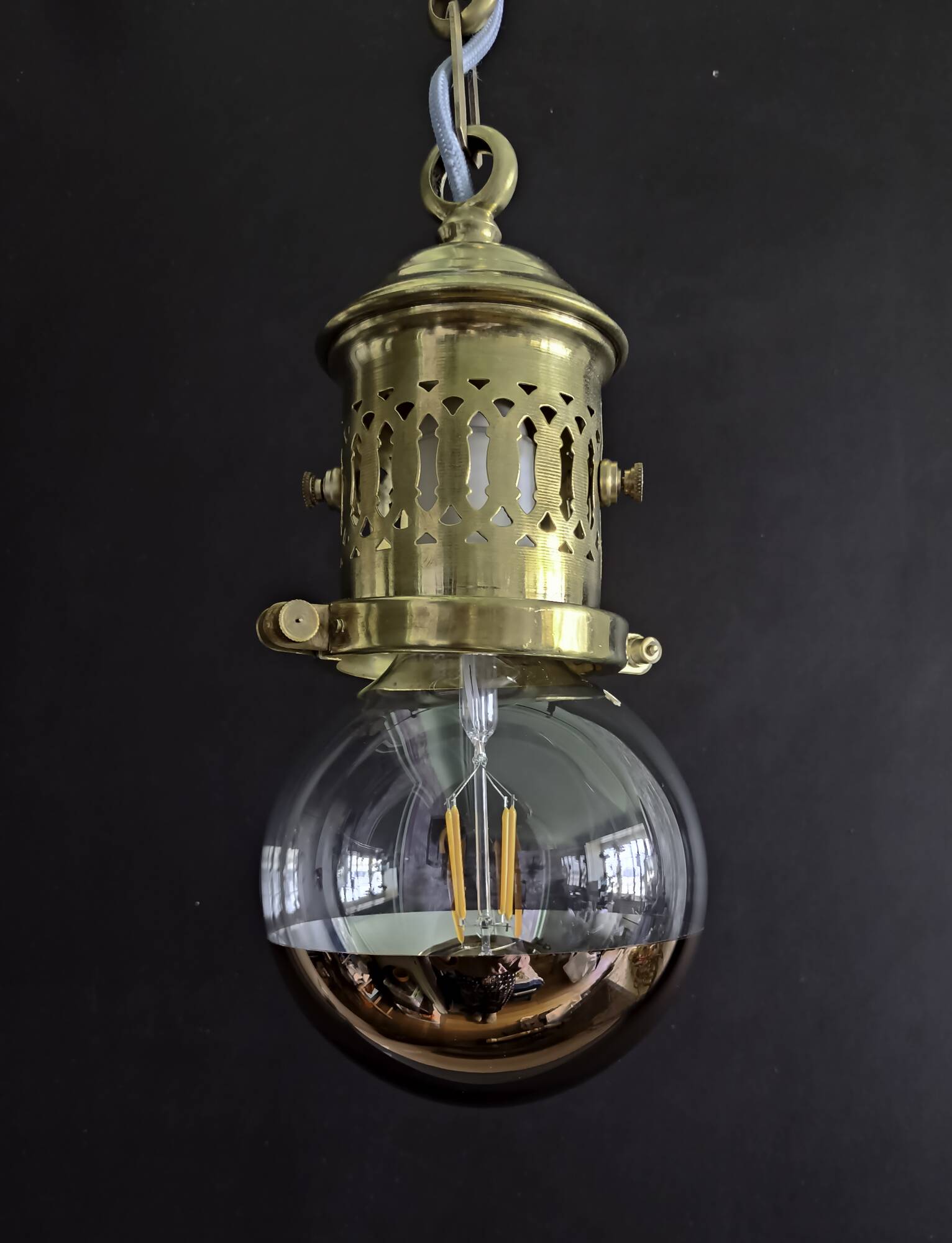 Brass pendant light with oversized LED bulb