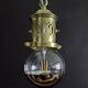 Brass pendant light with oversized LED bulb