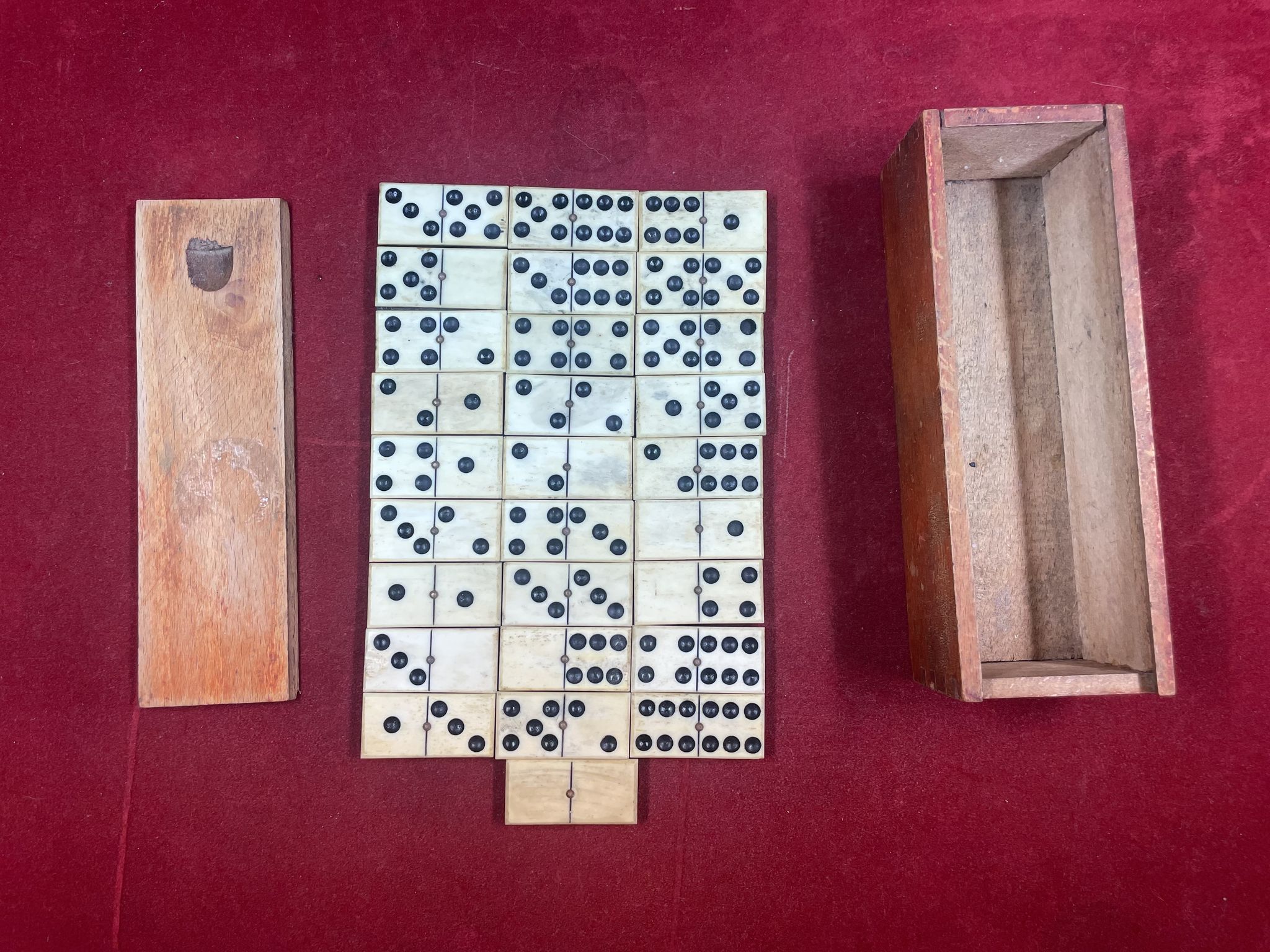 Set of complete dominoes made of bone, nails and blackened wood