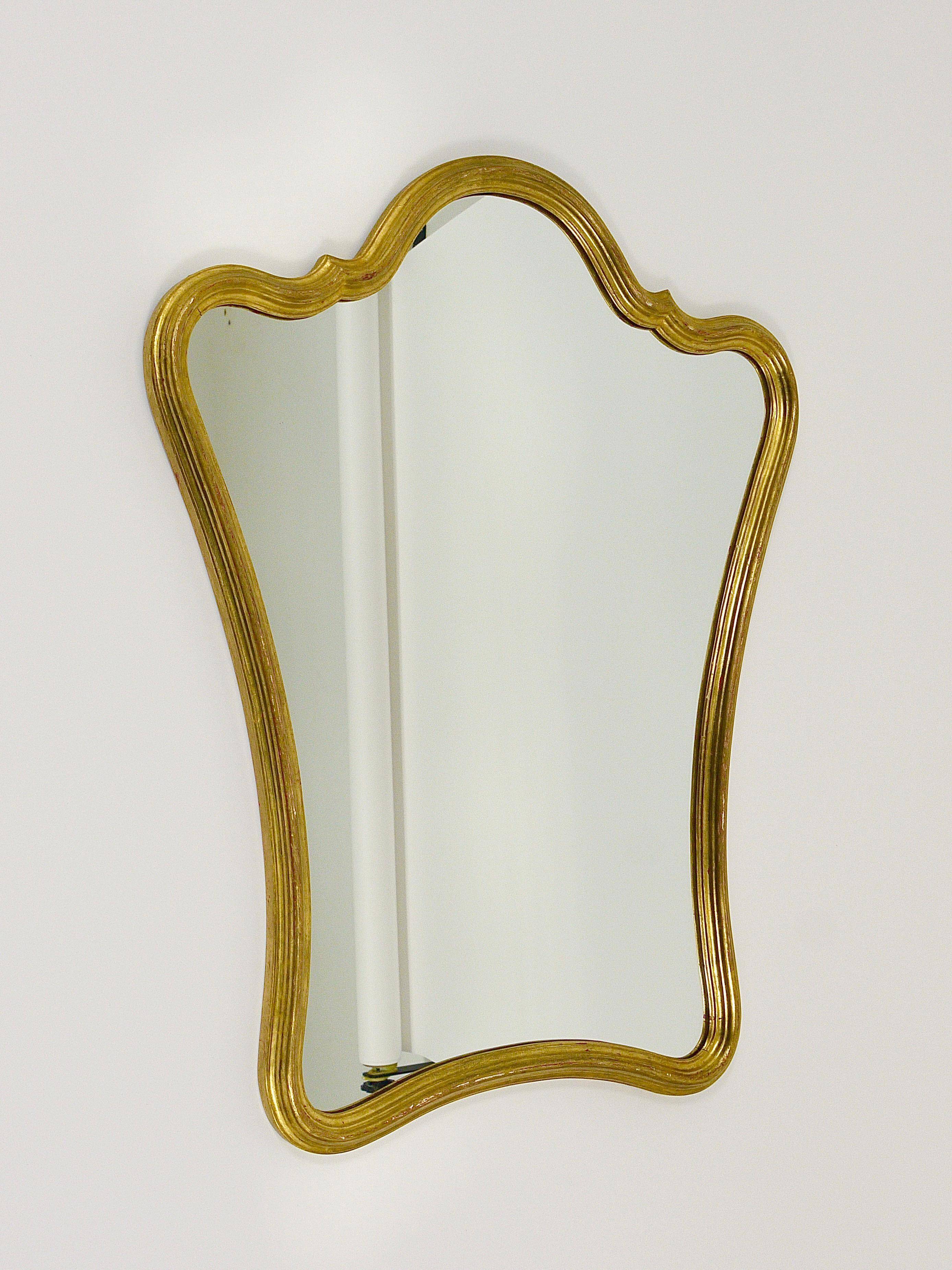 Curved wall mirror in gilded wood Chelini Firenze, mid-century, Italy, 1950s.