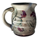 Floral decorated pitcher signed