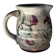 Floral decorated pitcher signed