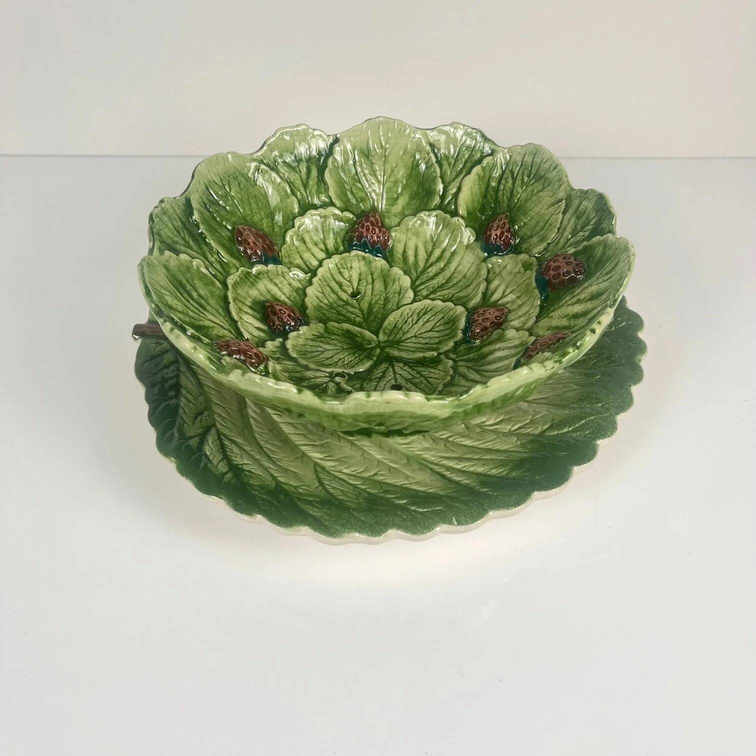 Leaf and strawberry-shaped bowl/strainer.