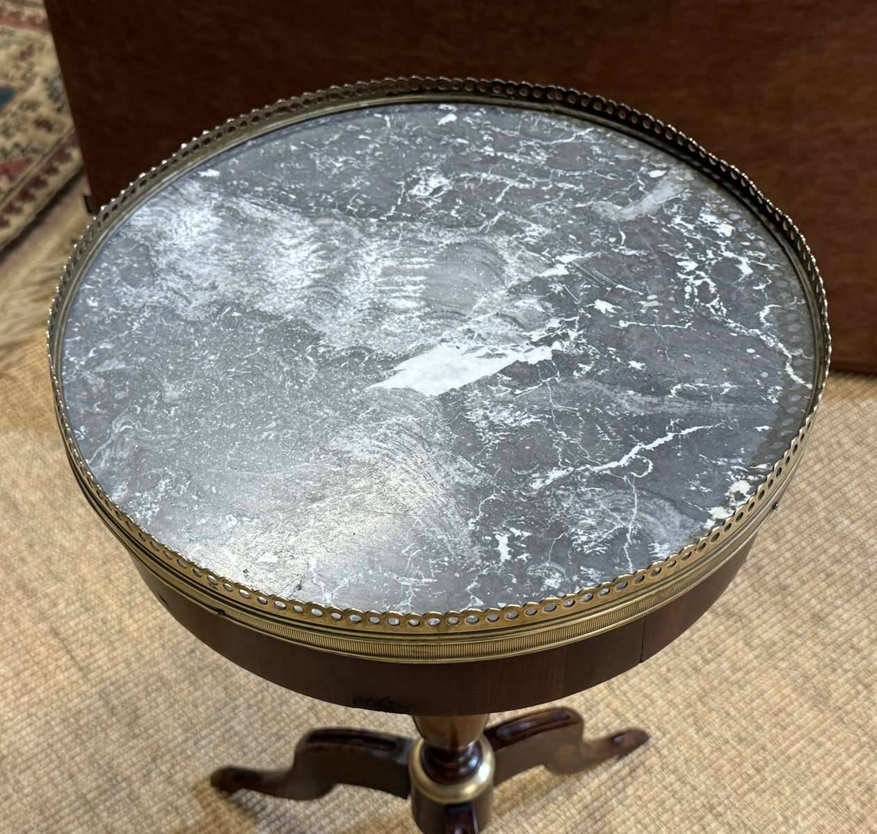 Mahogany gueridon with marble top from the 1950s.