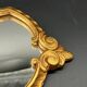Miroir style baroque – bois doré sculpté – volutes et coquille