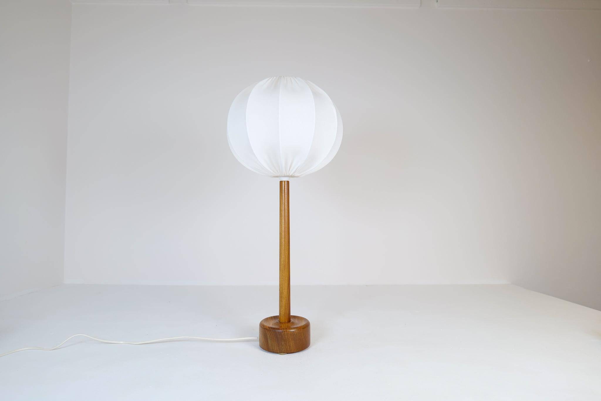 Mid-century solid teak table lamp from the 1960s Sweden.