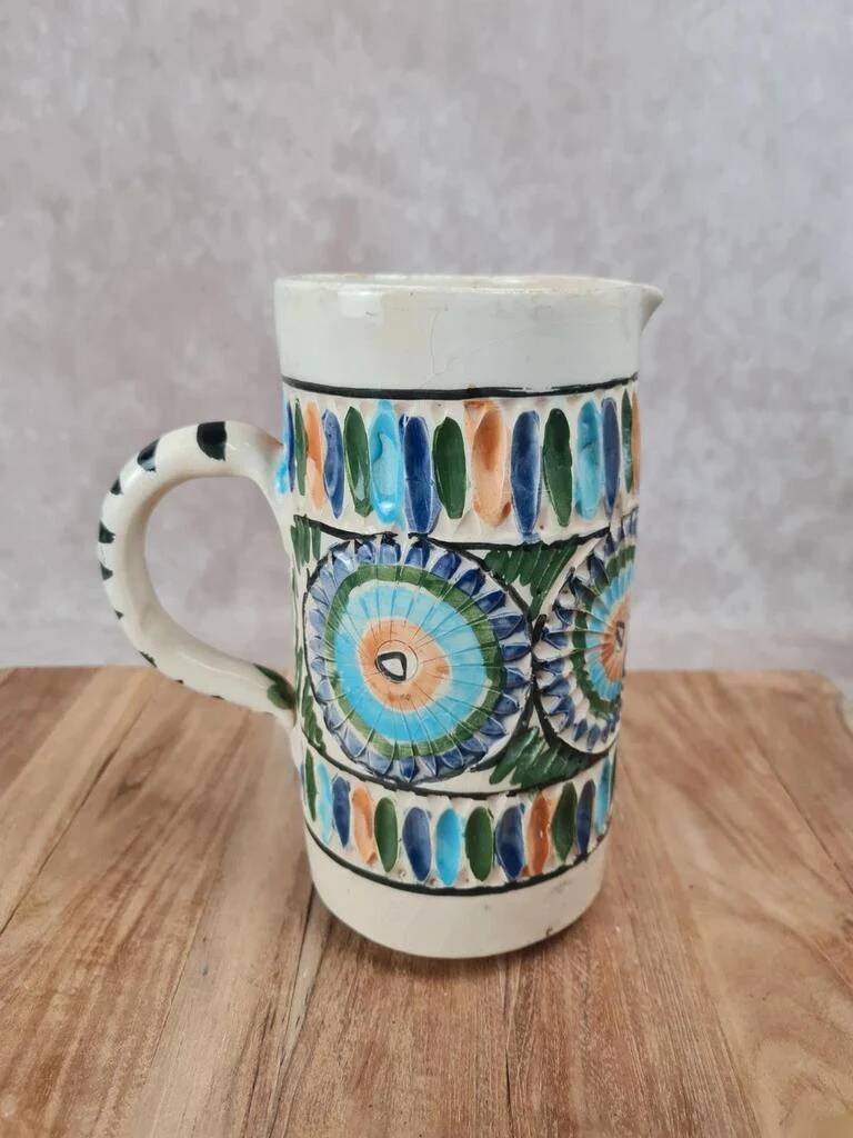 Old pitcher in Tunisian earthenware with colourful decoration.