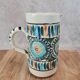 Old pitcher in Tunisian earthenware with colourful decoration.