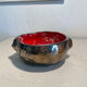 Deep red glazed and metallic ceramic catchall.