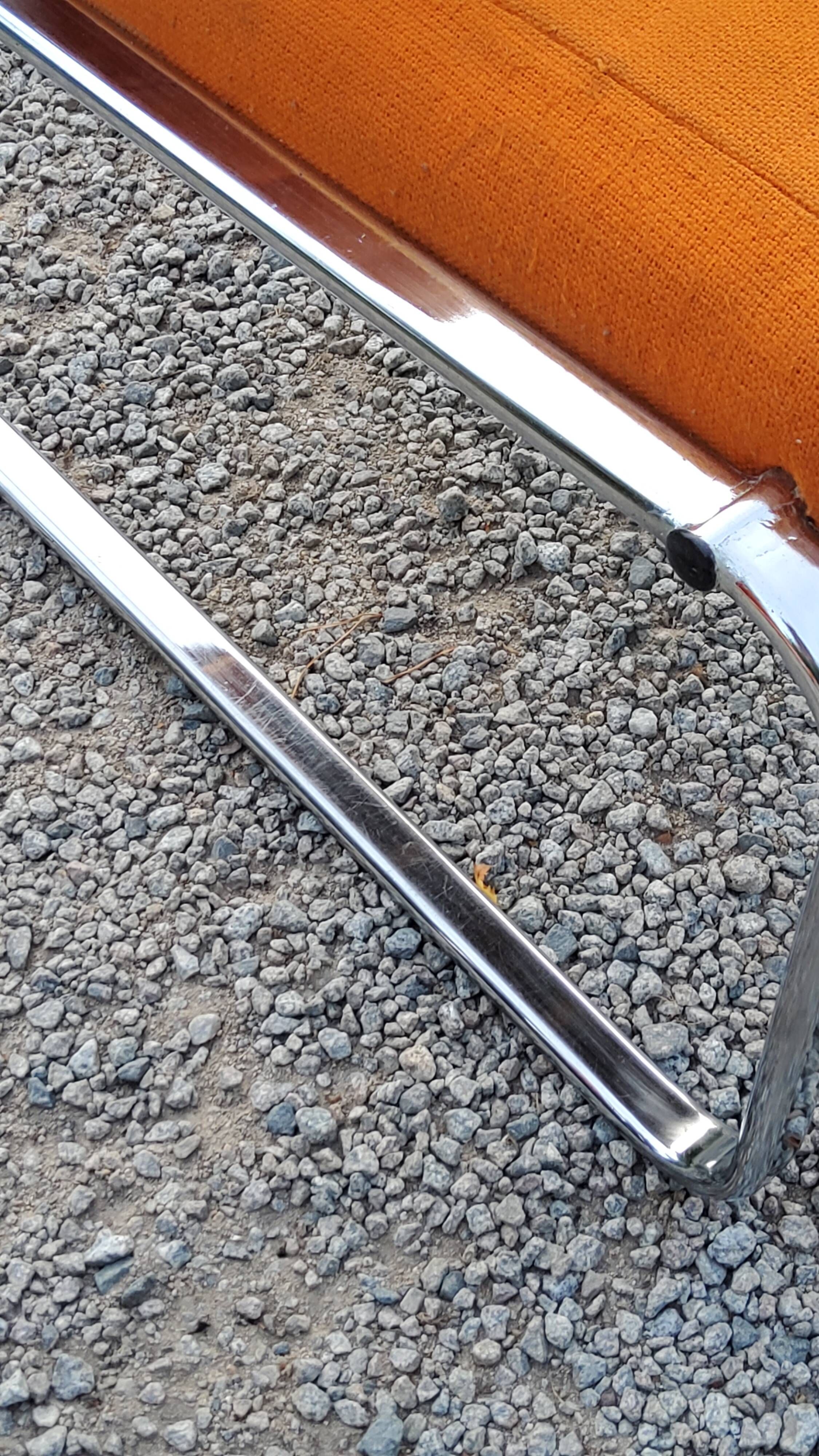 Pair of designer armchairs in orange fabrics and chrome tubes from the 70s