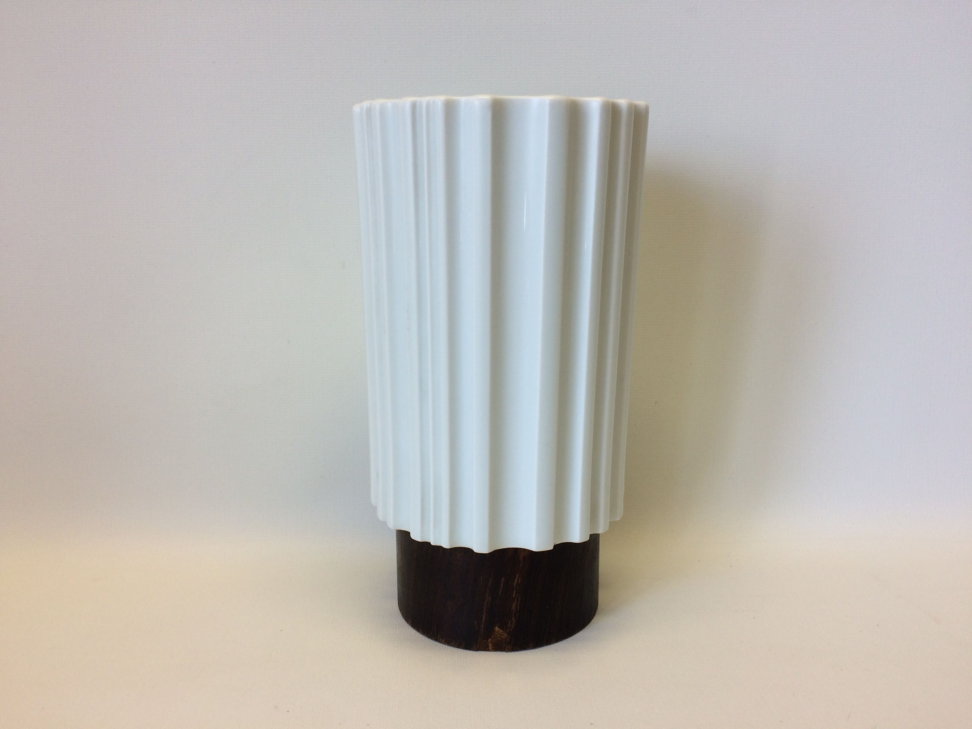 White vase on wooden base