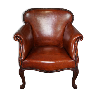 Old armchair in sheep leather