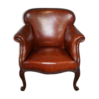 Fauteuil ancien en cuir de mouton