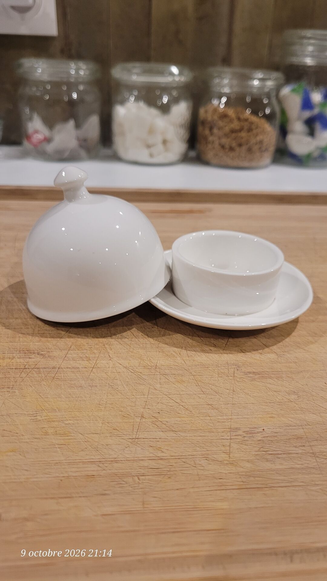 White porcelain butter dish accompanied by its matching bell.