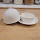 White porcelain butter dish accompanied by its matching bell.