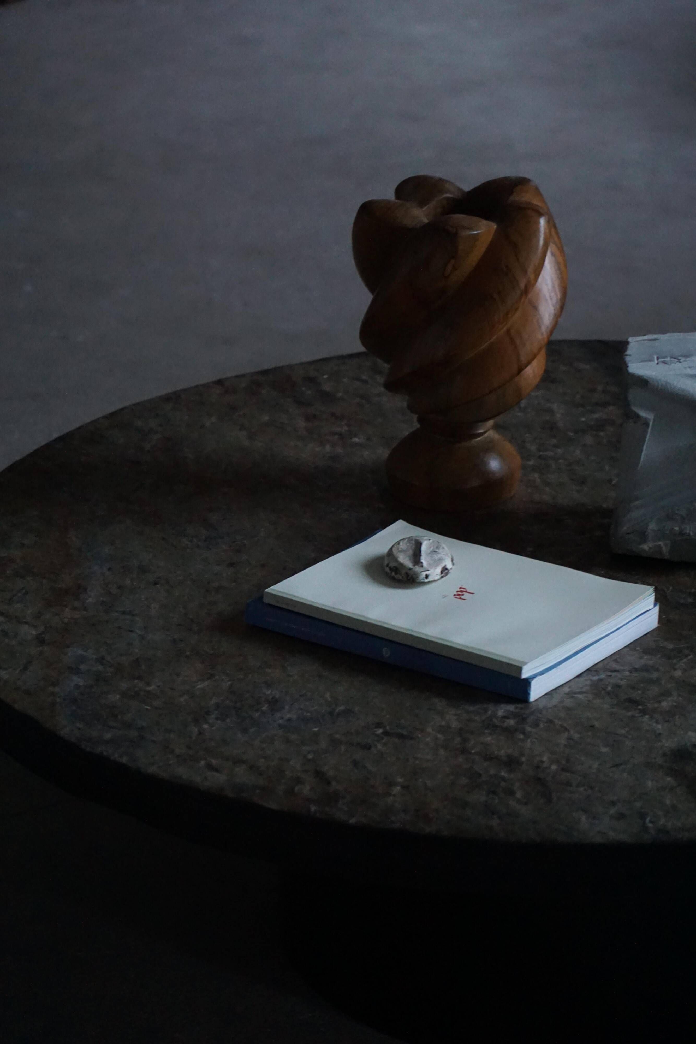 Round brutalist coffee table in stone and steel, mid-century French modernism, 1970s.