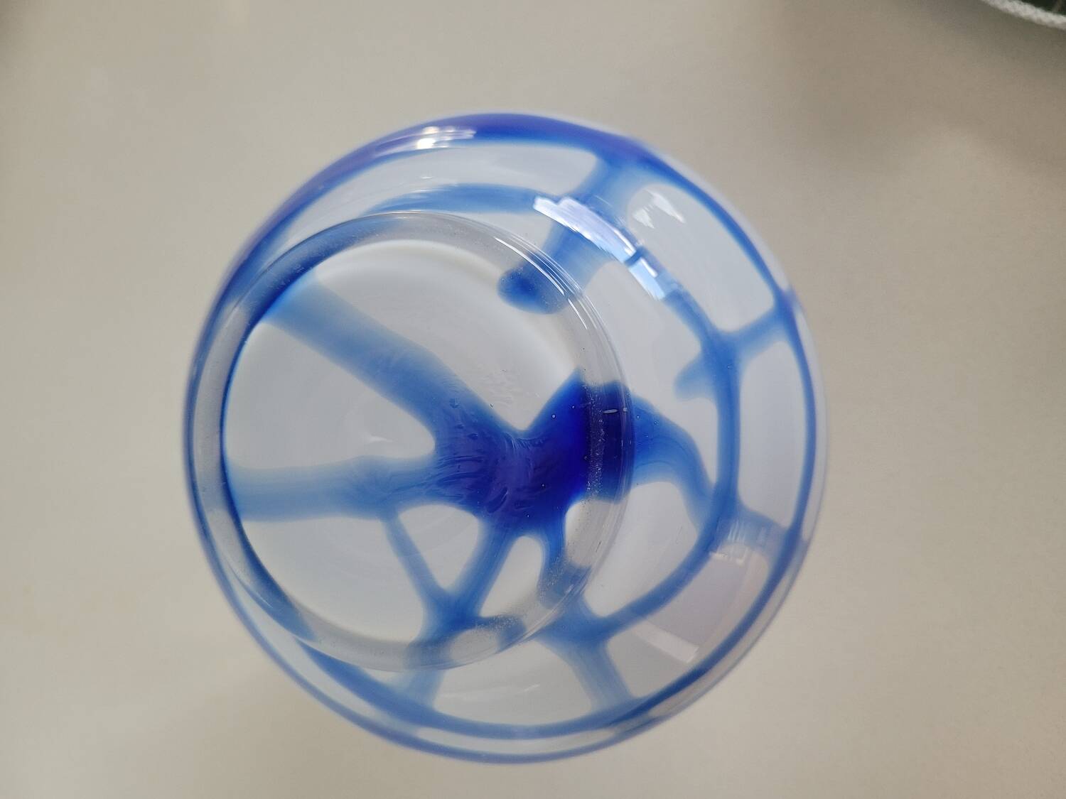Old white and blue glass flower vase