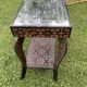 Carved wooden quadrupedal pedestal table
