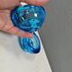 A set of iitalla candle holders in blue transparent glass.