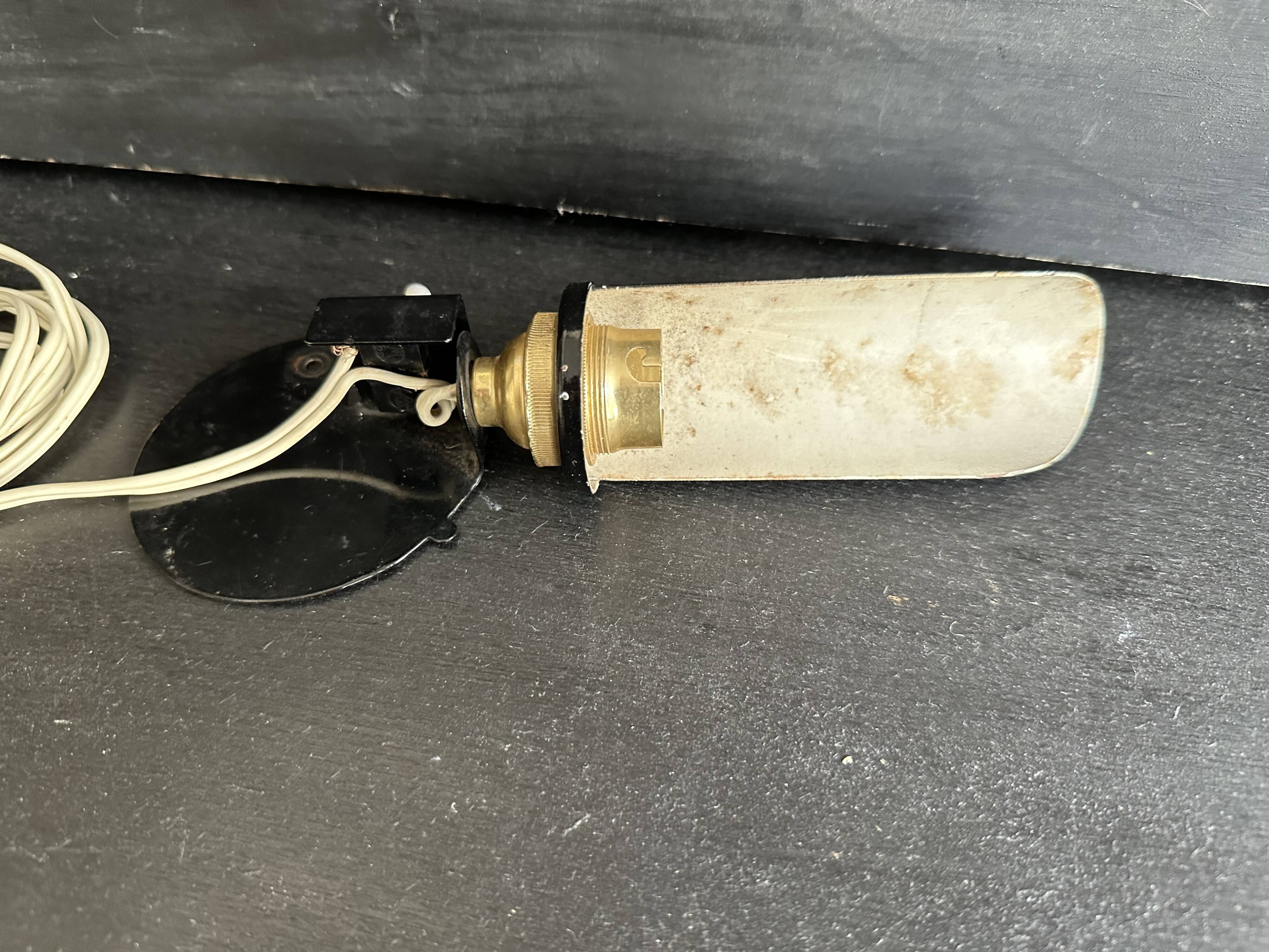 Old black metal and brass wall light, adjustable, 1930s.