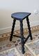 Antique tripod stool in turned wood, painted black – Half-moon seat