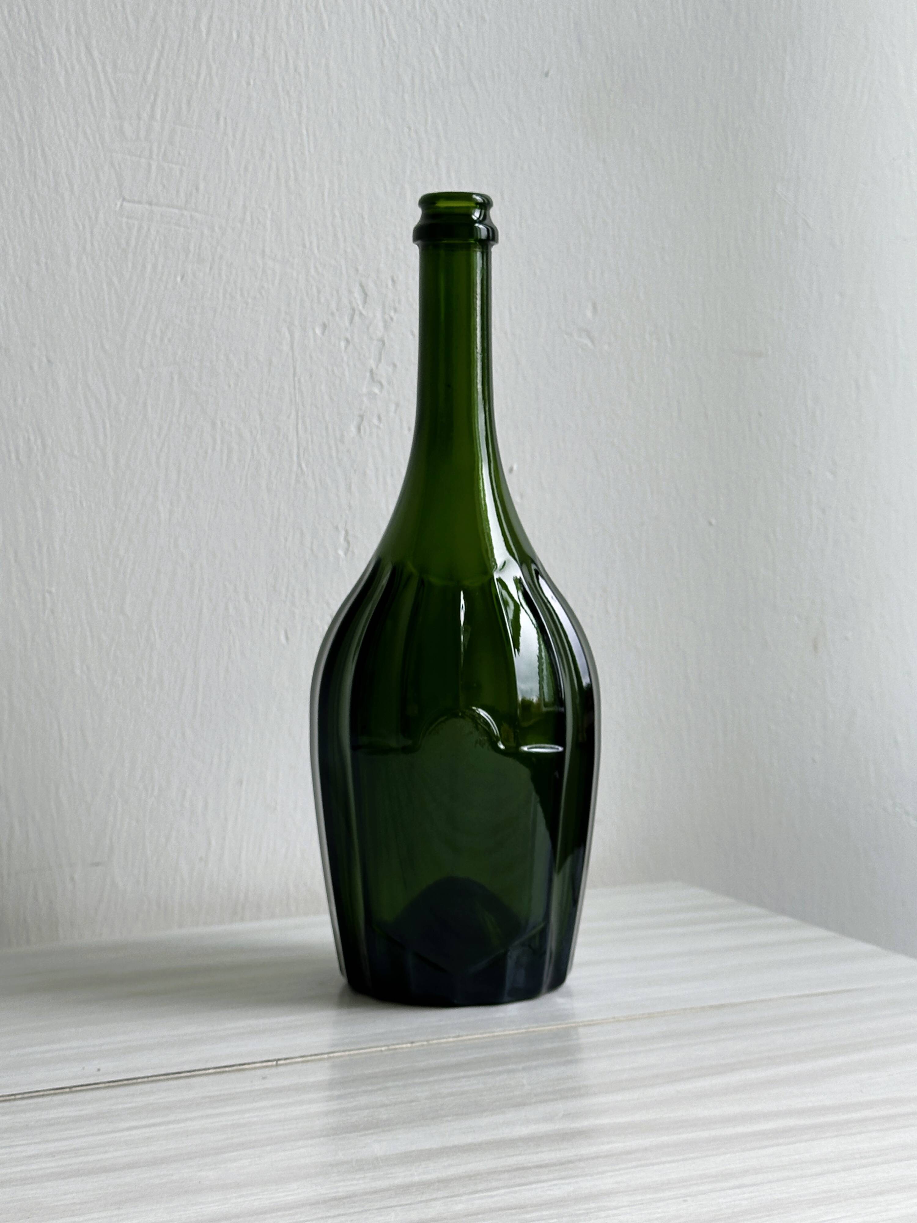 Translucent green glass bottle, classic design.