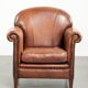 Sheepskin armchair with comfortable seat and finished with decorative nails