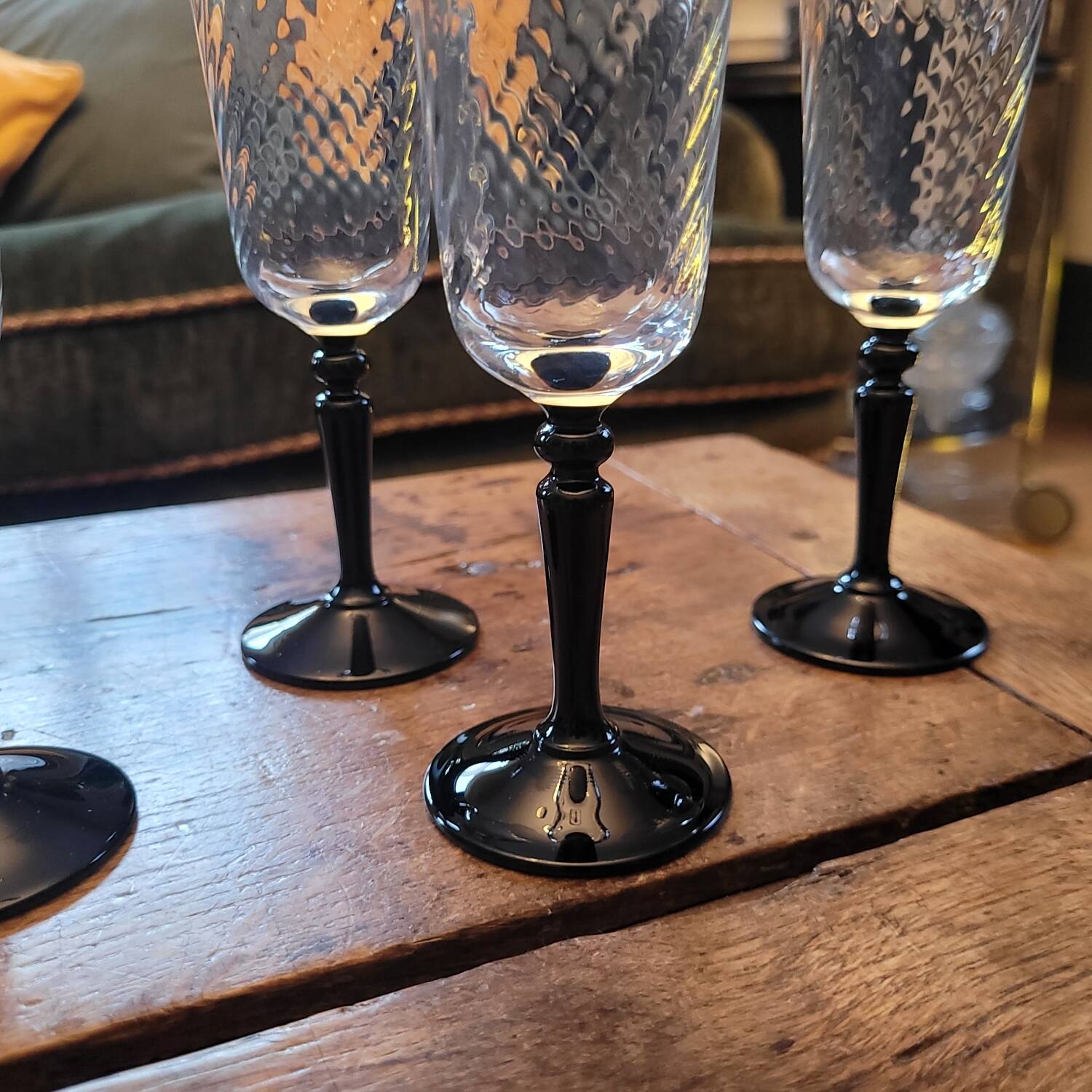 4 clear glass flutes with black stems. 1960–1970. 4 clear glass flutes with black stems.
