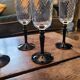 4 clear glass flutes with black stems. 1960–1970. 4 clear glass flutes with black stems.