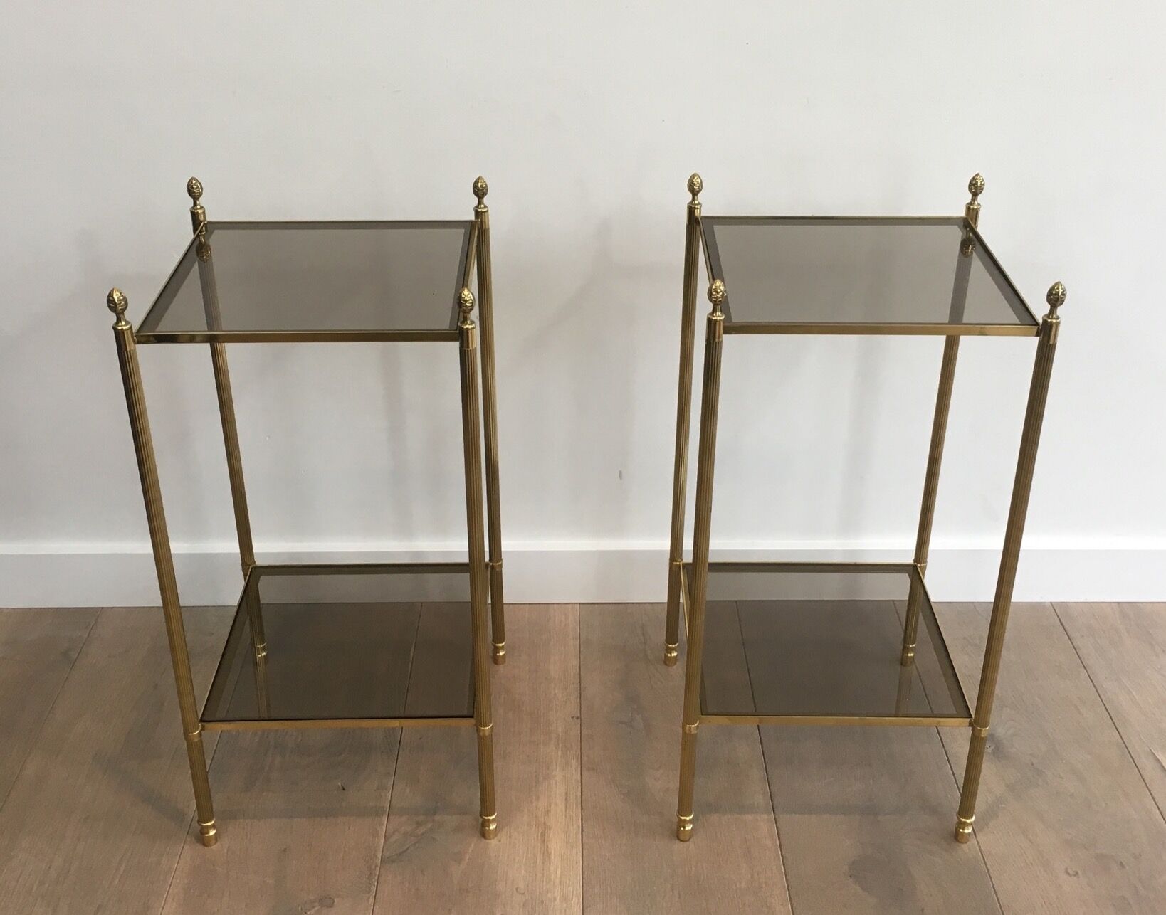 Pair of neoclassical style sofa ends in gilded metal and glass