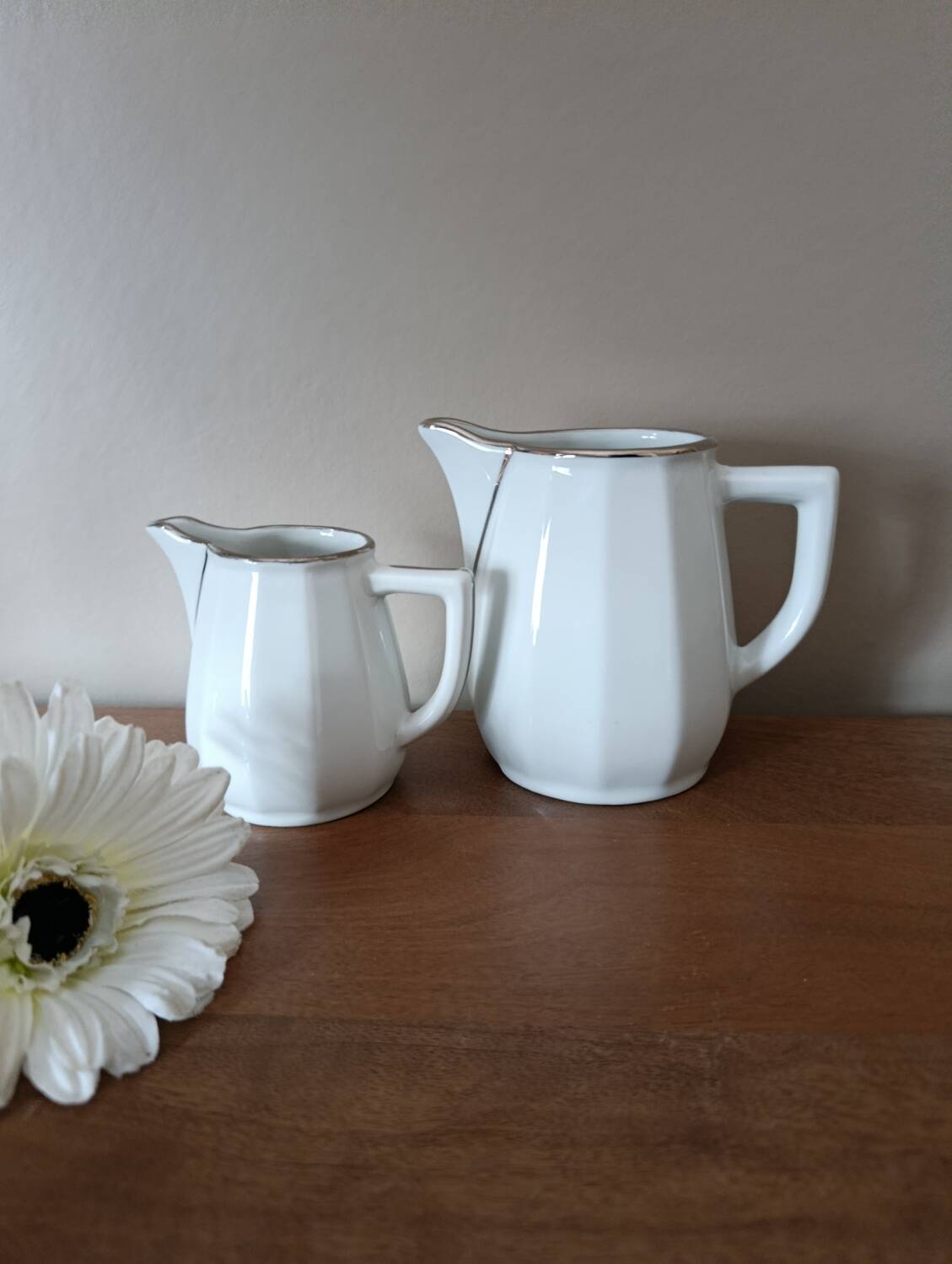 2 white porcelain milk jugs with platinum trim, Flora by Apilco.