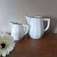 2 white porcelain milk jugs with platinum trim, Flora by Apilco.