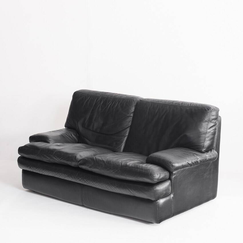 Black leather two-seater sofa. Roche Bobois edition. France, 1980s.