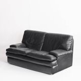 Black leather two-seater sofa. Roche Bobois edition. France, 1980s.