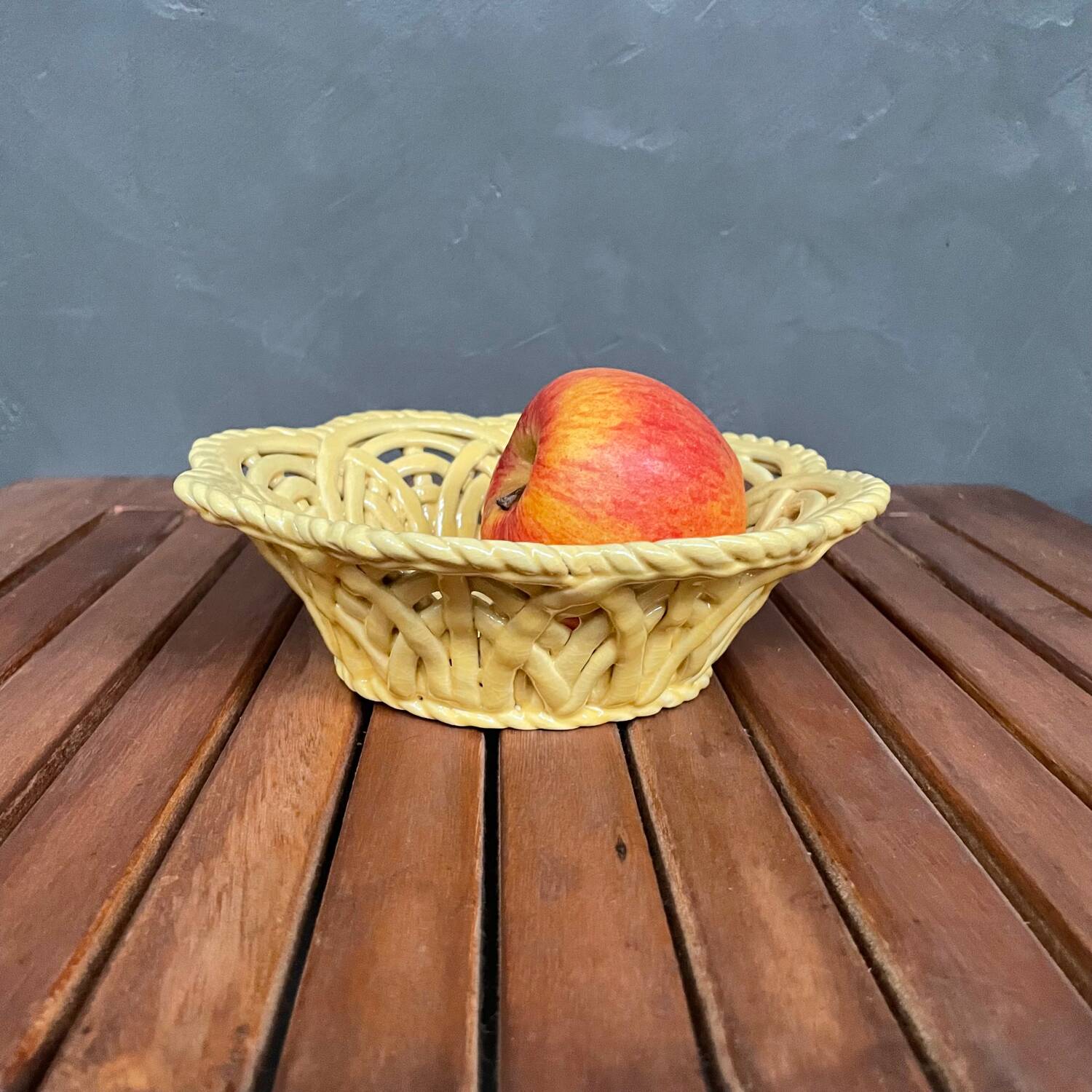 Yellow openwork woven earthenware basket