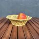 Yellow openwork woven earthenware basket